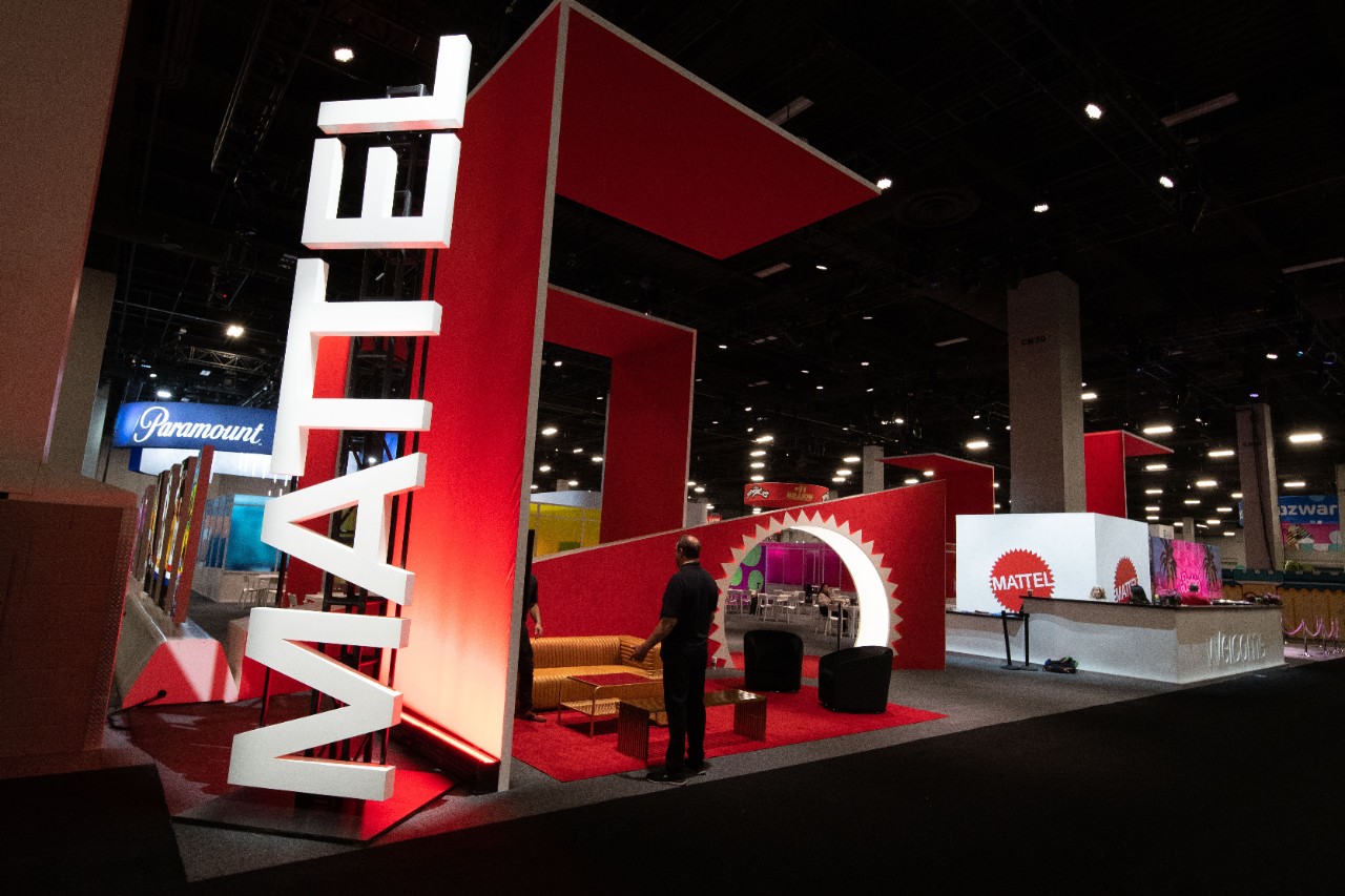 Mattel exhibition stand with prominent red branding and featuring product displays at Licensing Expo